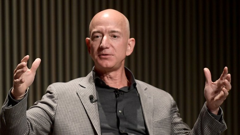 Jeff Bezos with hands raised