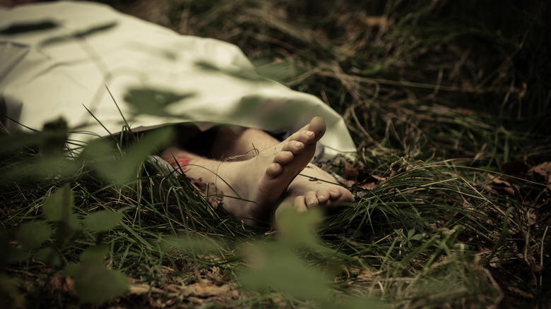 body under sheet with feet exposed