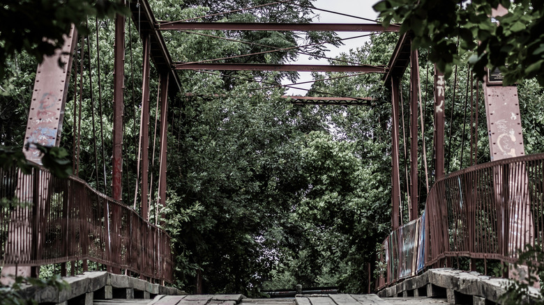 metal goatman's bridge bushy trees