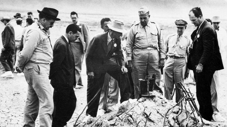 Oppenheimer viewing rubble with military outside
