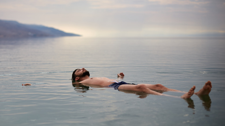 man floating on Dead Sea