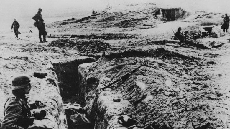 soldiers standing over destruction on ground