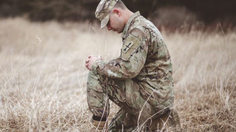 soldier kneeling mourning