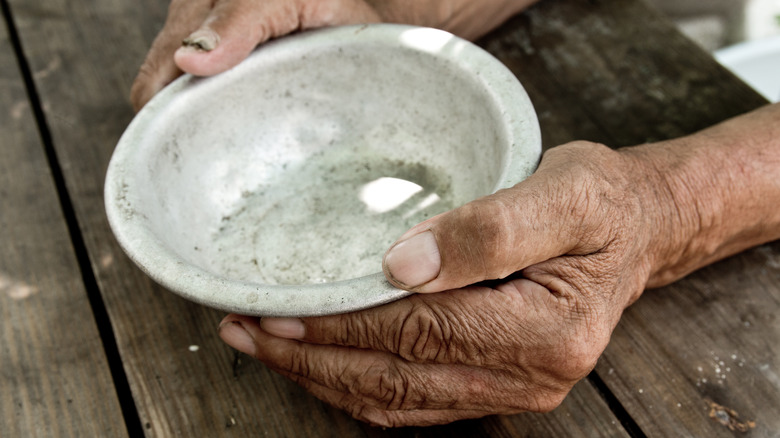 hand with empty bowl