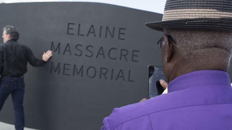 Man standing by Elaine massacre memorial