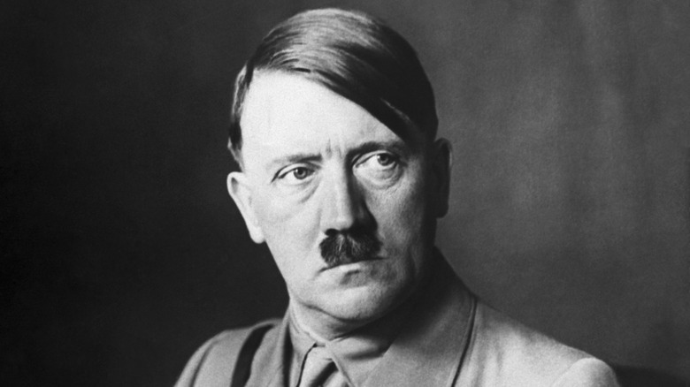 Adolf Hitler sat looking to his left in uniform