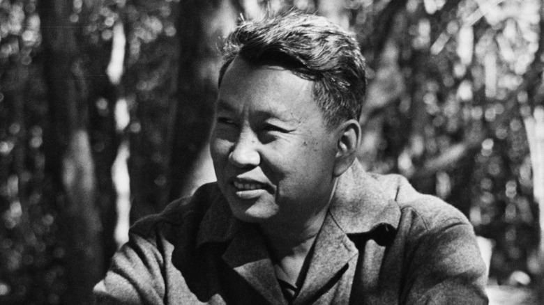 Pol Pot smiling in jacket in jungle
