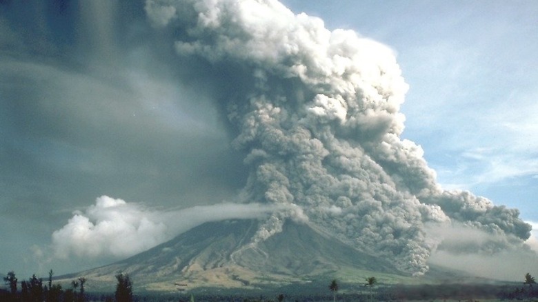 billowing clouds smoke plum above volcano