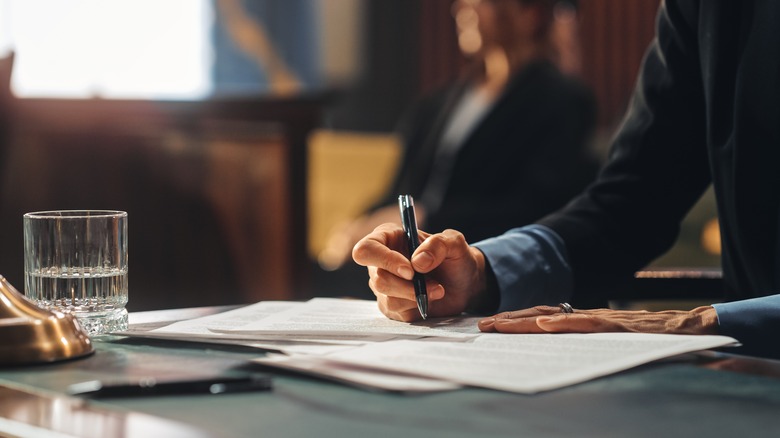 person writing legal paperwork