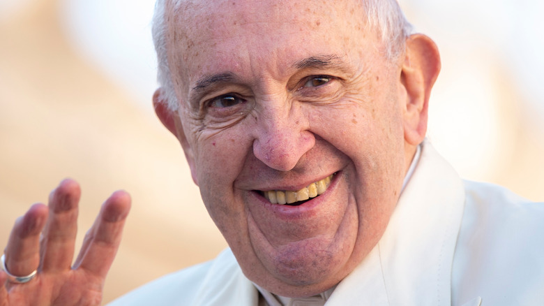 Pope Francis waving to worshipers at the Vatican