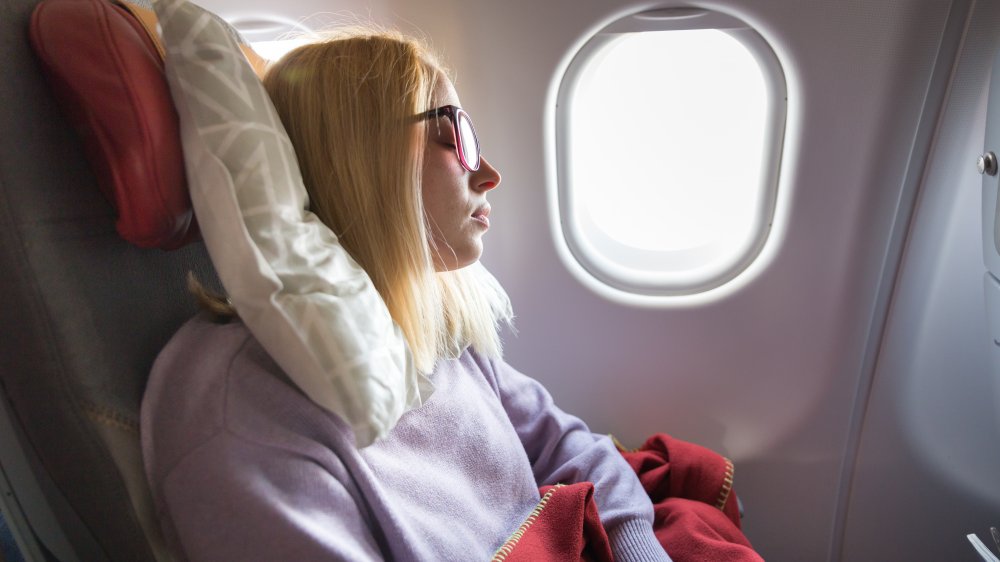 Woman sleeping on plane