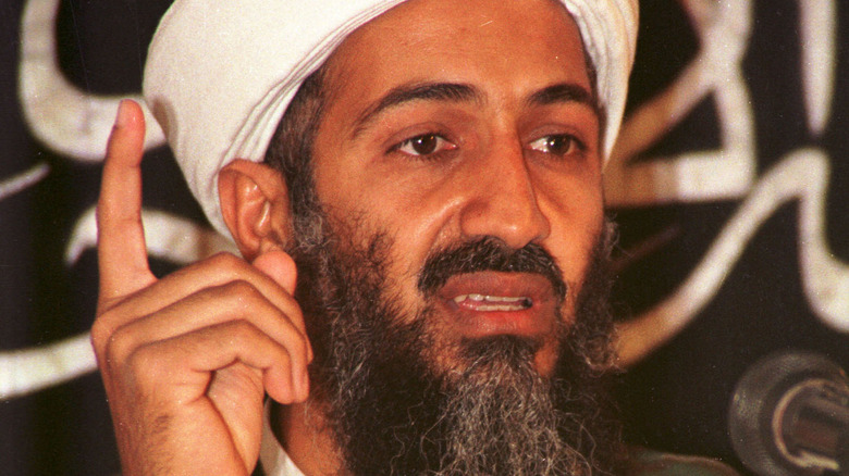 Osam Bin Laden holding finger up