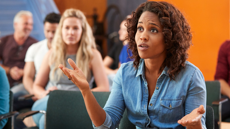 Woman voicing concerns at town hall meeting