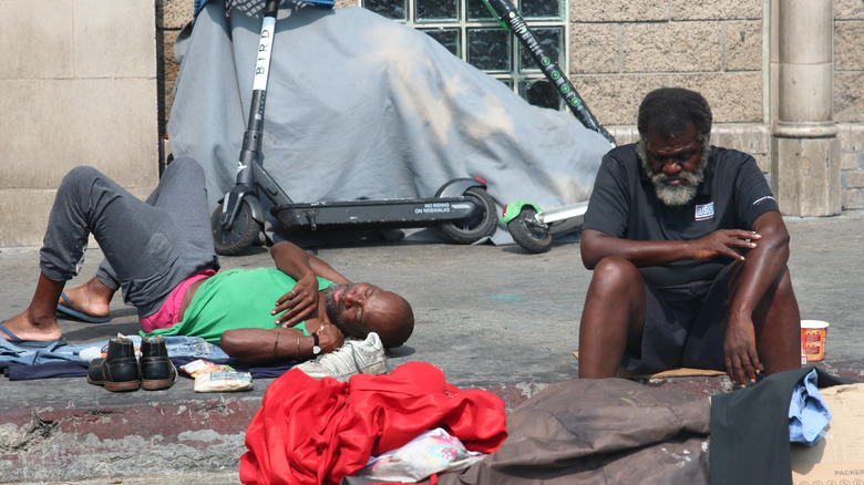 Homeless men laying in the street