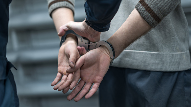 person being arrested in handcuffs