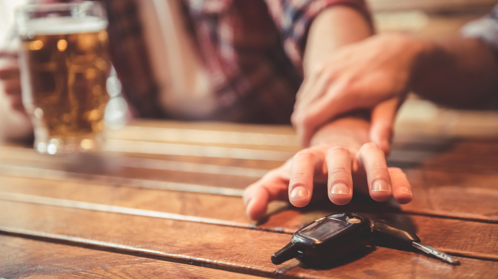 Guy at the bar reaching for his keys