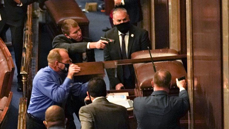 Security in the US Capitol barricade a chamber holding guns
