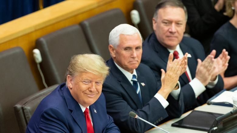 Mike Pence Mike Pompeo applaud Donald Trump smiling