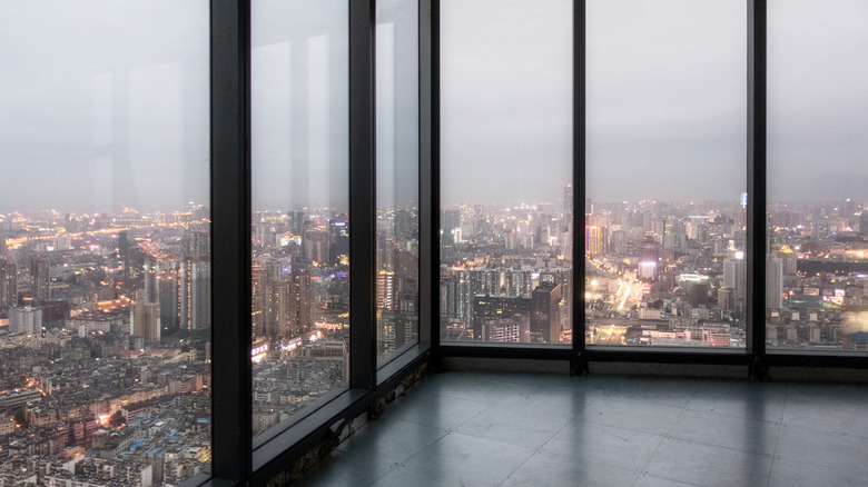 skyscraper windows looking over city from inside