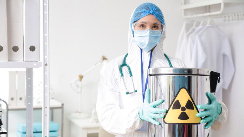 woman in PPE holding radioactive material