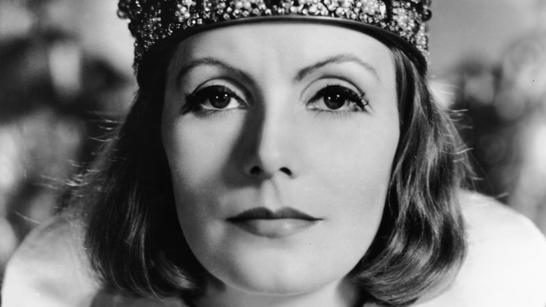 Greta Garbo in close up wearing a crown in her role as Queen Christina