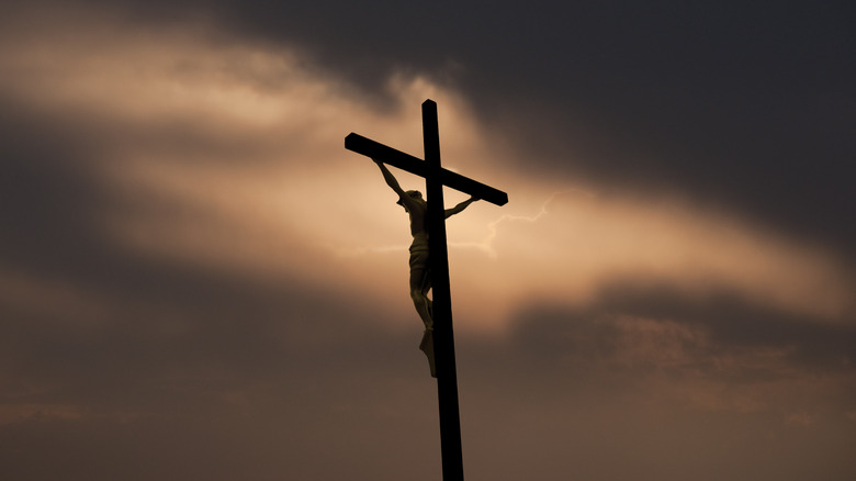 Crucified Jesus under dark sky