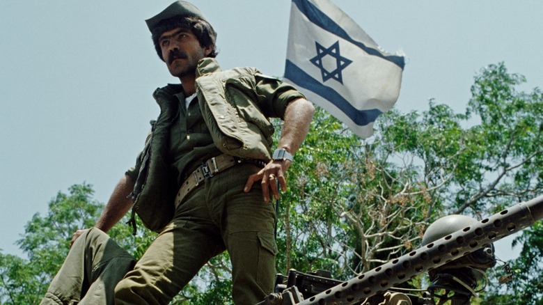 Israeli soldier standing on tank