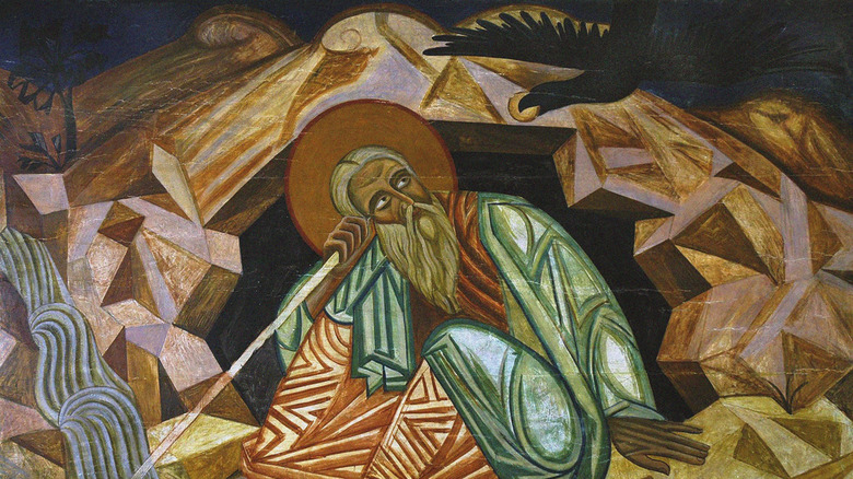 Prophet Elijah sits in front of rocks