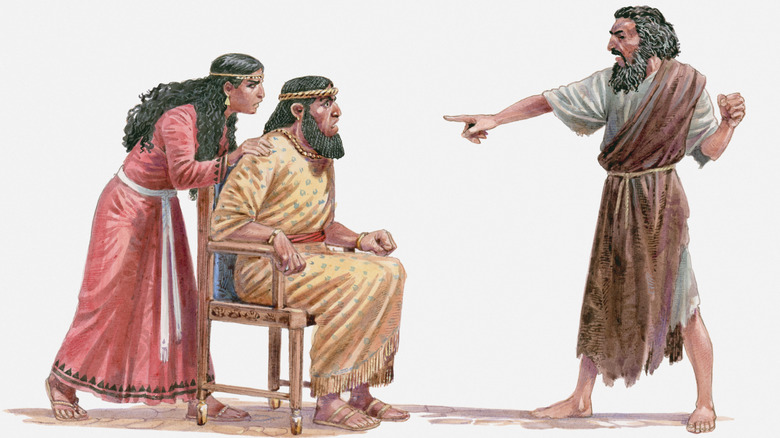 The prophet Elijah stands in front of Ahab and Jezebel, accusing them