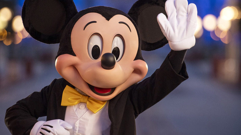 Mickey Mouse waving at sunset