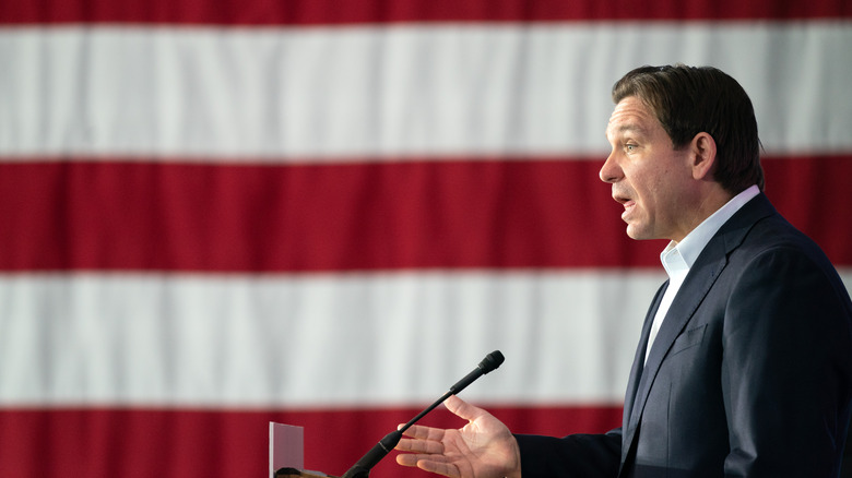 Ron DeSantis giving a speech American flag