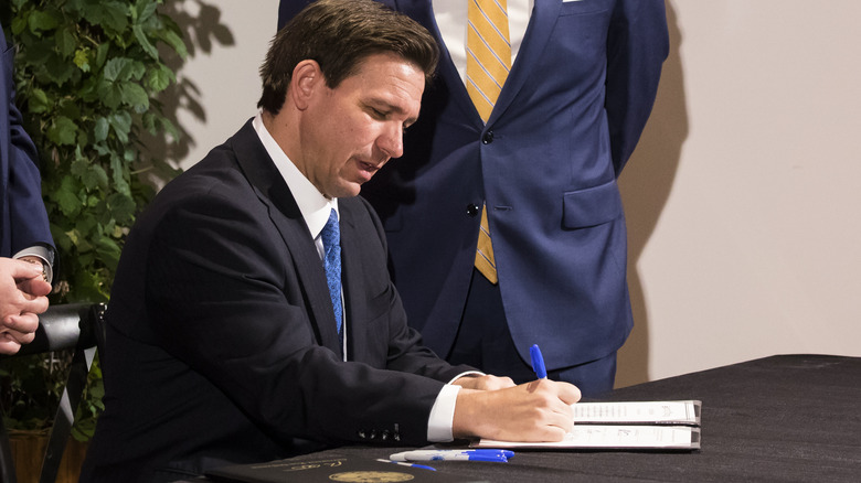 Ron DeSantis signing a bill