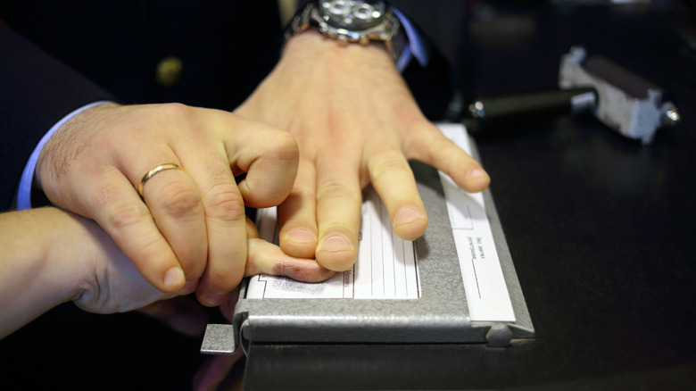 hands fingerprinting fingers