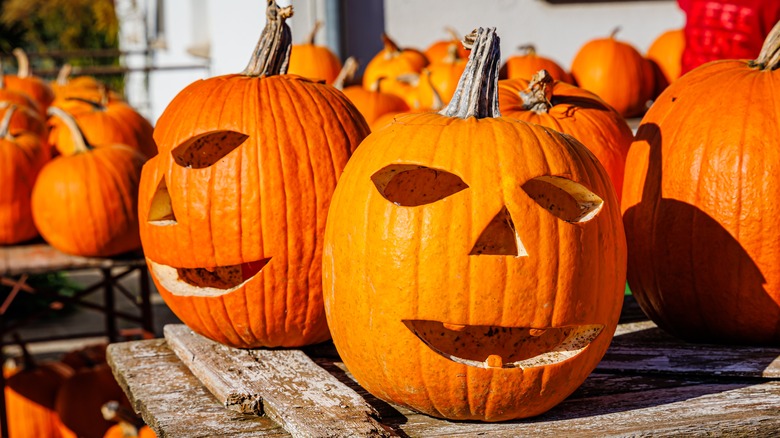 Carved orange pumpkins on wooden table