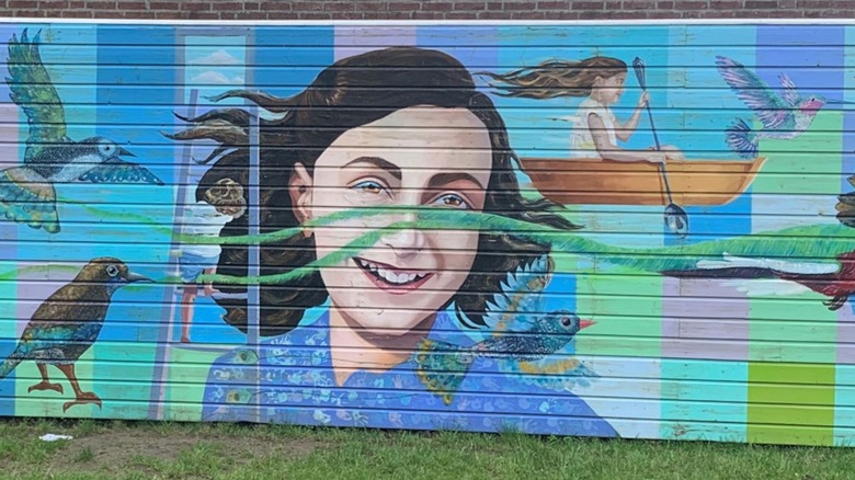Anne Frank mural on wooden wall