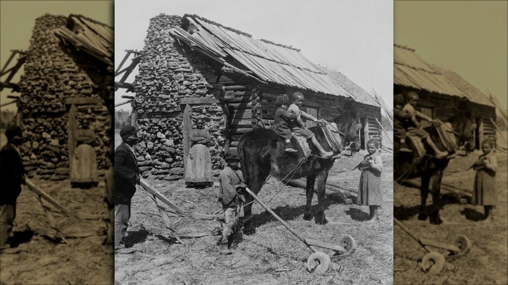 Black family outside their rural home in 1903