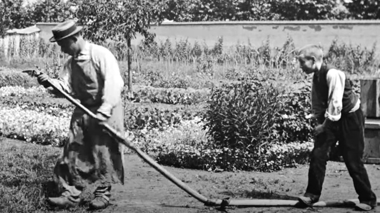Little boy pranking gardener