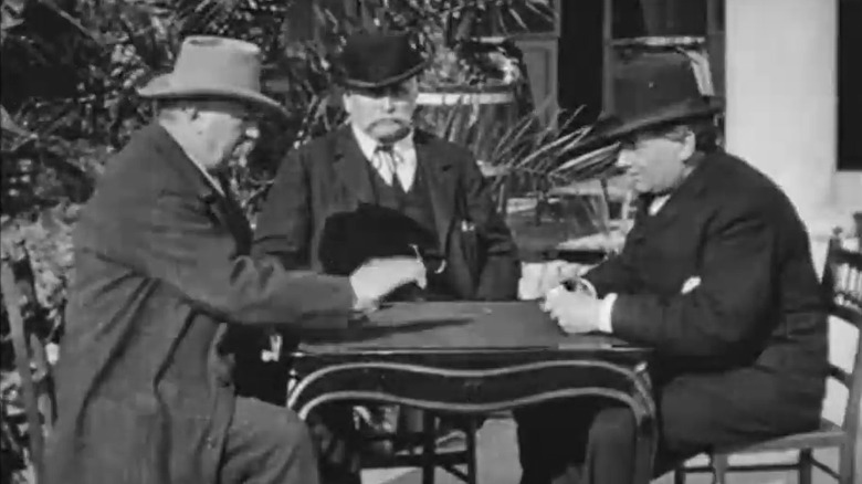 Three men sitting at table