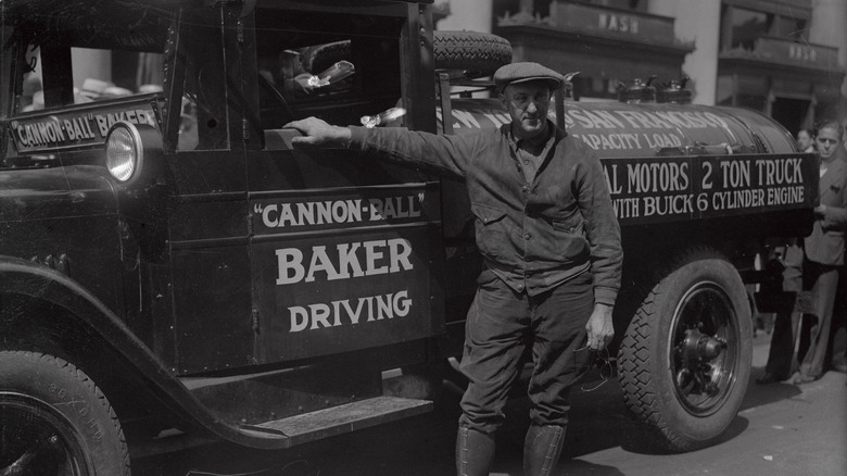Cannonball Baker poses next to Buick truck