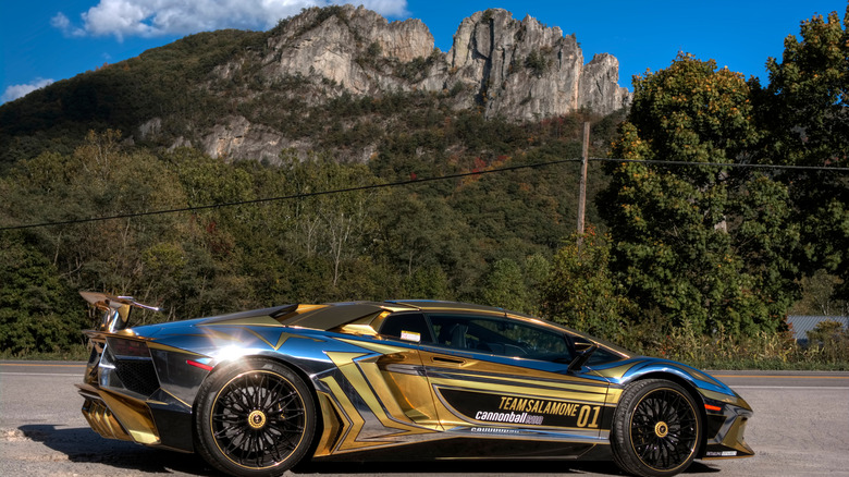 Sports car with cannonball run livery outside with mountains in background