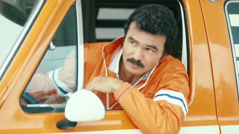 J.J. McClure (Burt Reynolds) looking outside his truck in Cannonball Run