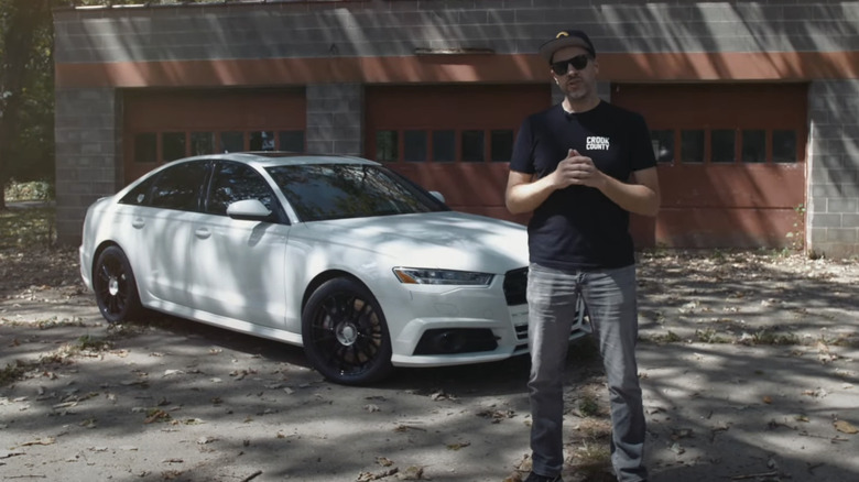Arne Toman talking in front of a 2016 Audi S6