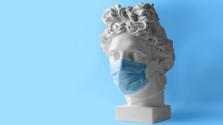 ancient statue with a mask