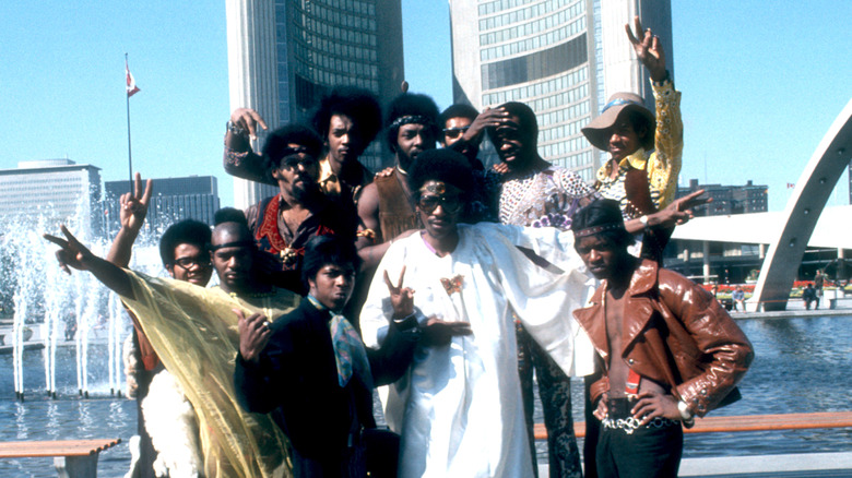 Parliament-Funkadelic posing in front of city buildings in the '70s