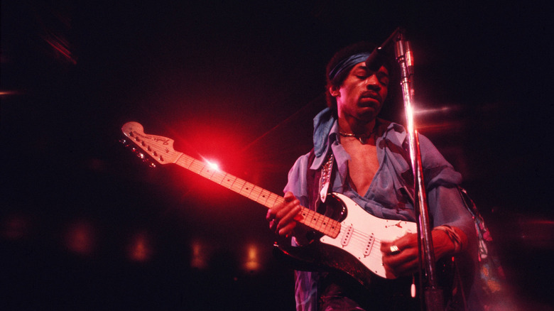 Jimi Hendrix playing guitar during live performance