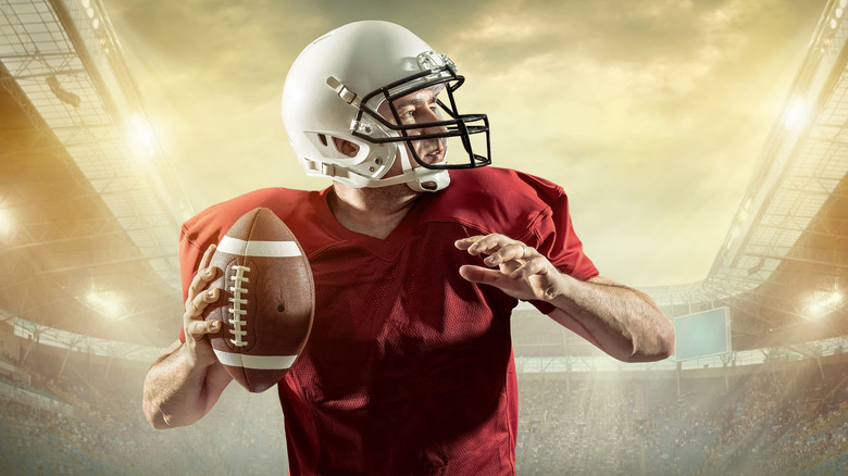 Football player holding ball