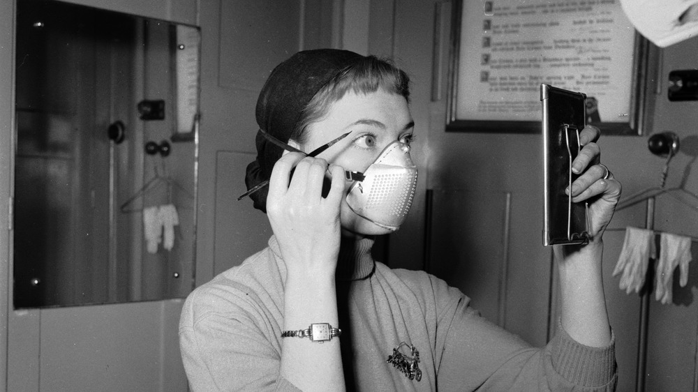 Woman working in London with mask.