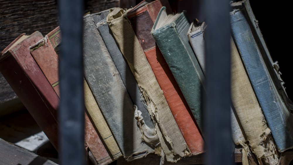 Old used books behind the metal bars.