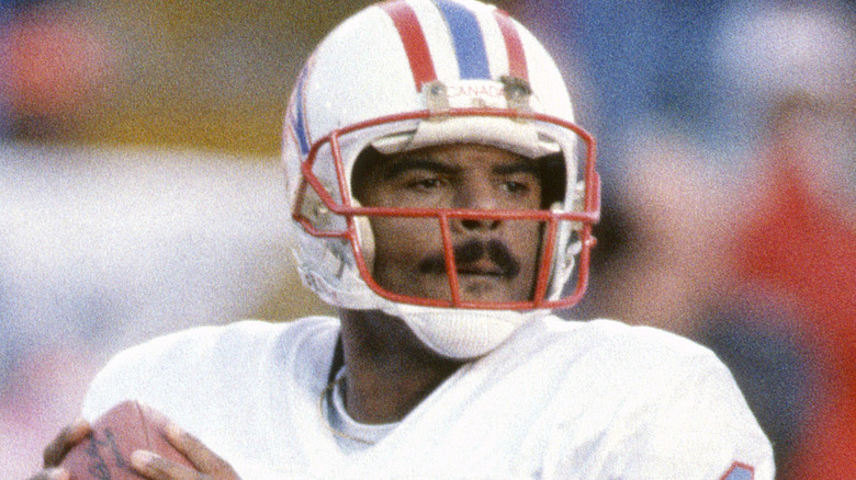 Warren Moon Houston Oilers holding football