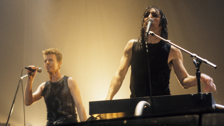 David Bowie and Trent Reznor performing onstage